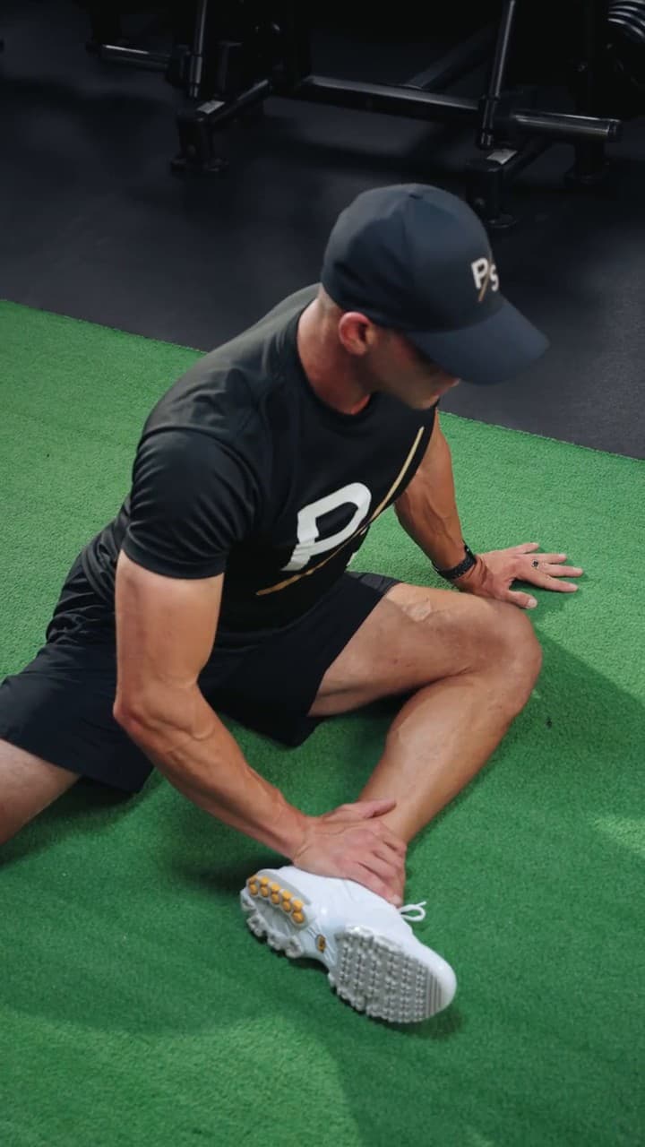 Chris Karagitsis in a 90/90 hip mobility position on training turf