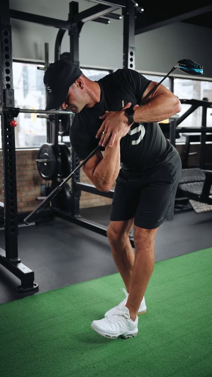 Chris Karagitsis rotating through a drill with a club held across his chest