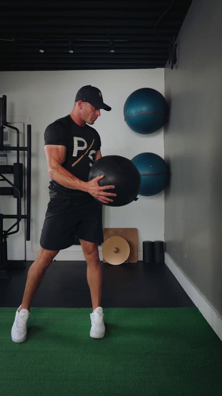 Chris Karagitsis loading a rotational medicine-ball throw against a wall