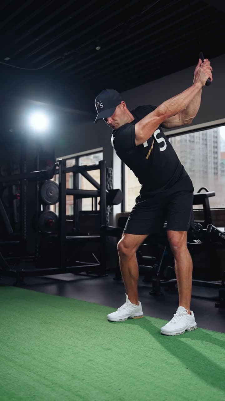 Chris Karagitsis at the top of a golf swing in the training space